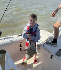 Pint-sized angler with a hefty Black Drum.